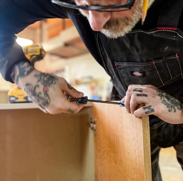 Master craftsman creating custom woodworking project in Detroit woodship.