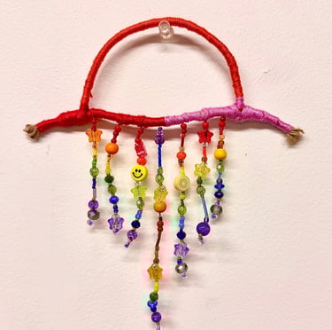 Woven beaded rainbow wall hanging