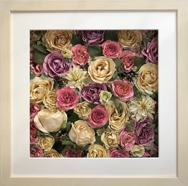 a beautiful summery flower wall style preserved wedding bouquet in a frame