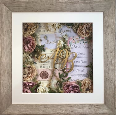 memory box full of wedding items and preserved wedding bouquet flowers in a deep frame