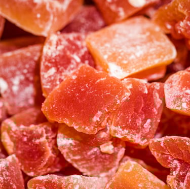 Close-up of red and orange semi-processed salt bricks and tiles, chipped from larger blocks.