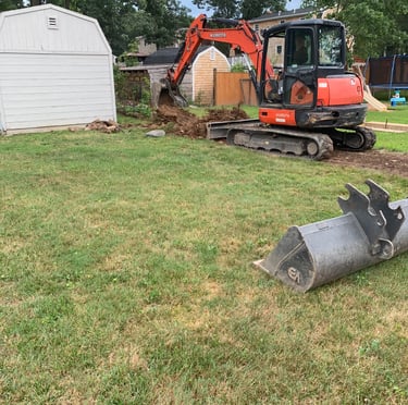 Digging dirt in a backyard for a landscaping project