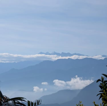 Majestic blue mountain ranges layered with thick white clouds under a clear sky. Sierra Nevada 