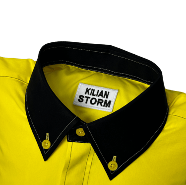 a yellow shirted pillow with a black collar and label