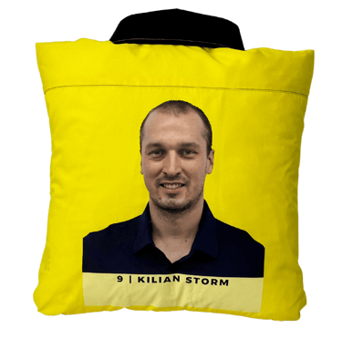 a yellow shirted pillow with a printed portrait on the back