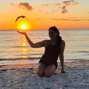 Laura Stella Life coach silhoutte on a beach sunset happy after overcoming burnout