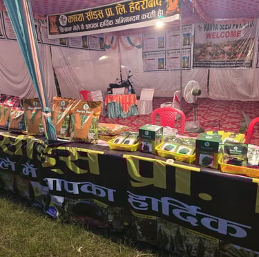 Kavya Seeds agricultural exhibition booth displaying hybrid corn and vegetable seed packets for farmers.