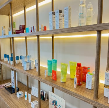 Professional medical grade skincare products on illuminated wooden pharmacy display shelves.