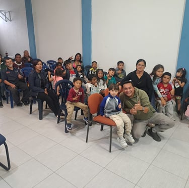 a man sitting in a chair with a group of children