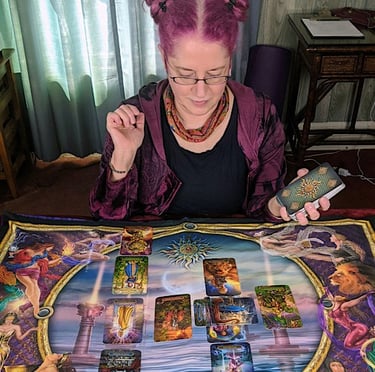 Renee looking at Tarot Cards on colorful Reading Cloth!