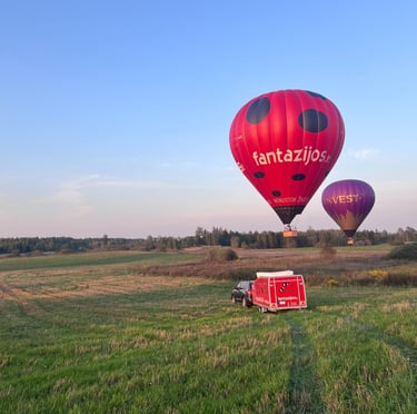 a red hot air balloon in the air vilnius