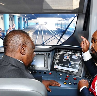 two men in suits and ties are looking at a train