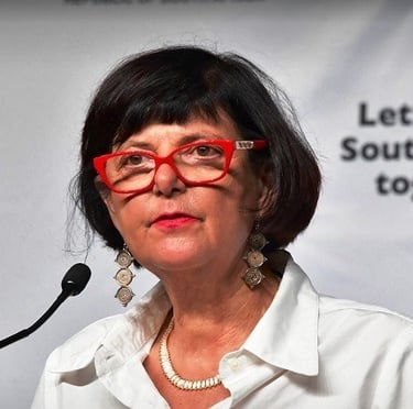 a woman in glasses and a white shirt