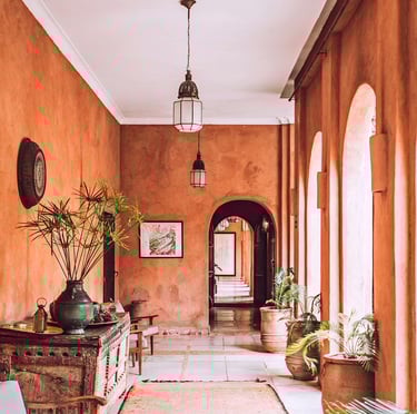 a welcome hallway with a large rug and a wooden table at reception. Guest Experience Enhancement