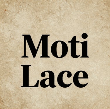 Close-up of delicate floral embroidery lace in soft cream tones.