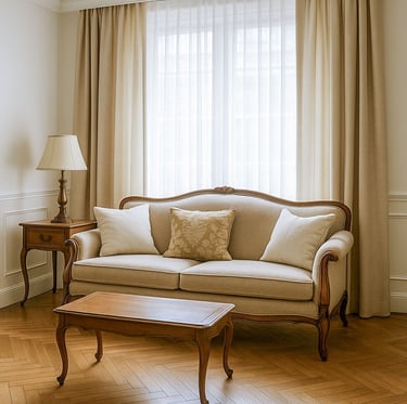 Traditional living room with vintage wood frame sofa, classic coffee table, and neutral drapes by Solo Home Decor.