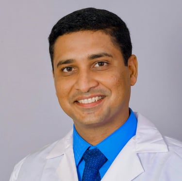 a man in a lab coat and tie dyes a blue tie