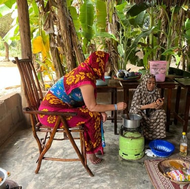 Tourist participating in a step-by-step cooking class coached by a local guide during a luxury Zanzibar spice tour, learning