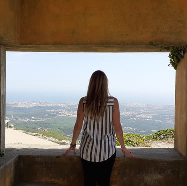 Martina looking at the view from a hilltop in Cascais, Portugal.