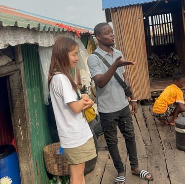 Dahomey African Tours Guide leading Tourists in Ganvie Stilt Village in Benin