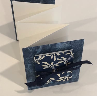 Accordion with Japanese paper and small accordion on cover, ribbon detail