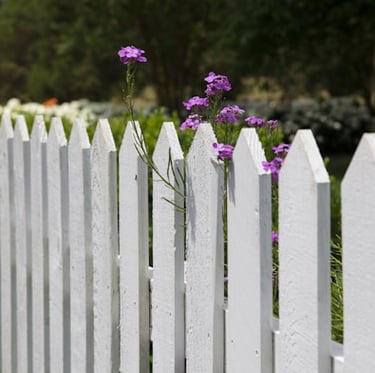 a tall wooden compost fence