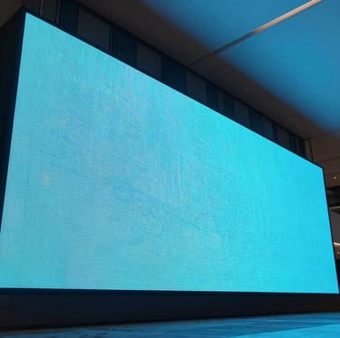 Sleek architectural photography of a massive curved LED display installed in a modern high-end corporate lobby, cool ambient light with sharp cyan screen glow