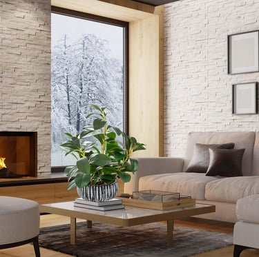 Modern living room with fireplace, potted plant, and snowy winter view through a large window.