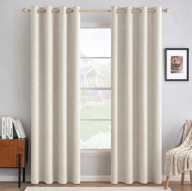 Elegant beige linen blackout curtains hanging on a wooden rod in a modern bright living room.