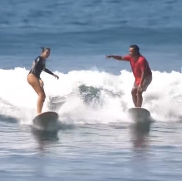 Ucup giving a surf lesson to Lise in Batukaras