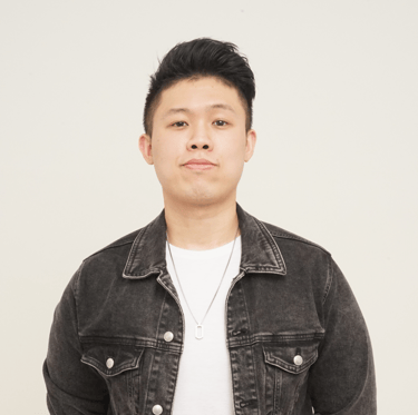 a man in a black jacket and white shirt