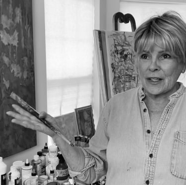 a woman in a denim jacket and jeans standing in front of a painting