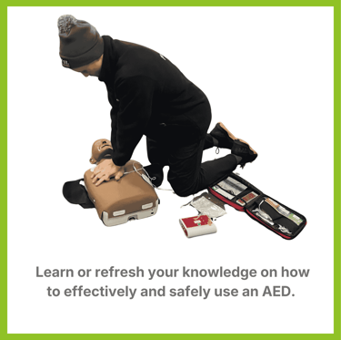 a student learning CPR on a manikin with an AED attached to the chest