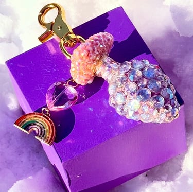 large bag charm of hand-sculpted heart-shaped butt plug covered in rhinestones with a rainbow charm