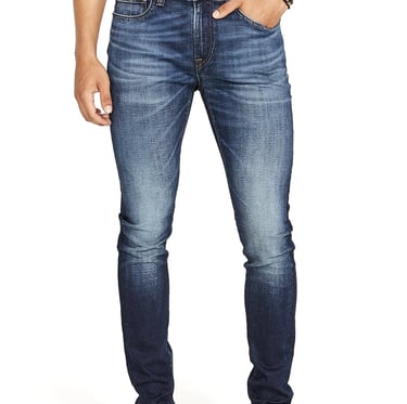 a man in a gray shirt and jeans