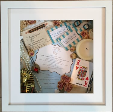 memory box full of wedding items and candle, playing card and preserved wedding flowers flowers