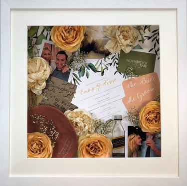 a photo of a memory box full of wedding items and preserved wedding bouquet flowers in a deep frame