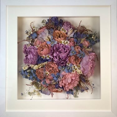 a photo of a Birdseye view preserved wedding bouquet in a frame