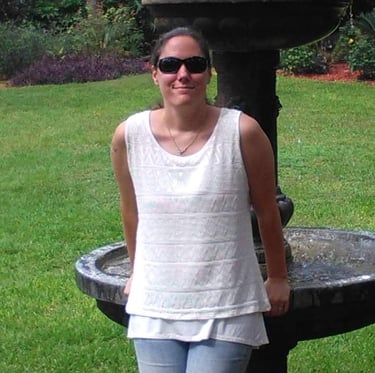a woman standing in front of a fountain