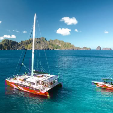 Private luxury yacht cruising through Bacuit Bay, El Nido.