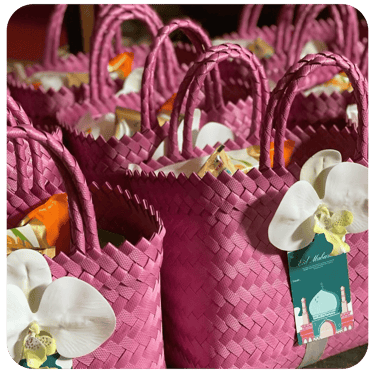 Pink handmade woven bag gift sets prepared for Eid celebration souvenirs.