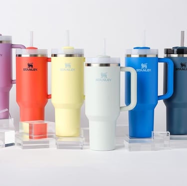 a variety of colored cups and cups of coffee and tea