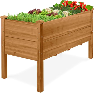 Elevated wooden raised garden bed filled with fresh vegetables and herbs on a white background.
