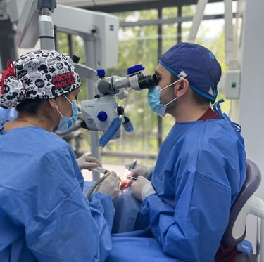 Professional dentist performing a root canal treatment using a high-precision dental microscope.