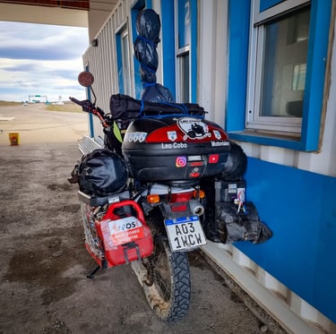 a motorcycle parked next to a building with a motorcycle