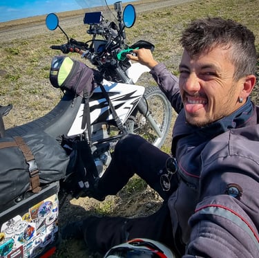 a man sitting on a motorcycle with a backpack on his back