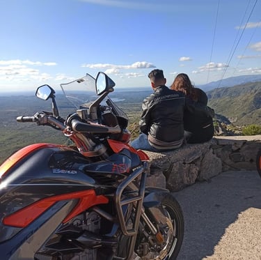 a man and woman sitting on a motorcycle