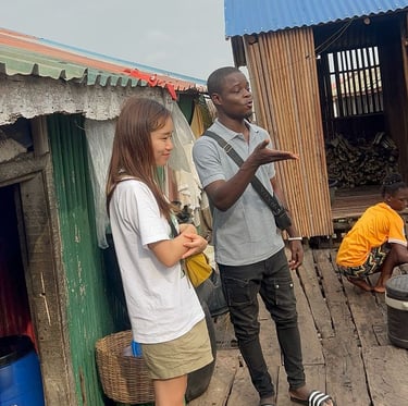 Dahomey African Tours Guide leading Tourists in Ganvie Stilt Village in Benin