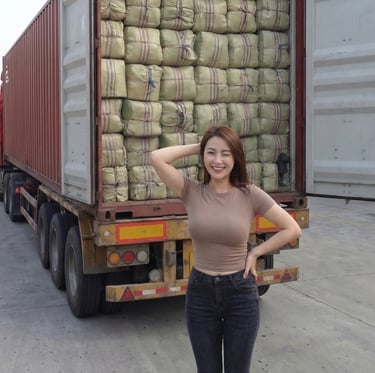 international business partner standing behind a container of dried Gracilaria seaweed, Indonesia