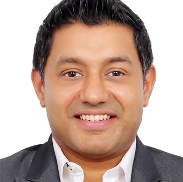 a man in a suit and tie smiling
